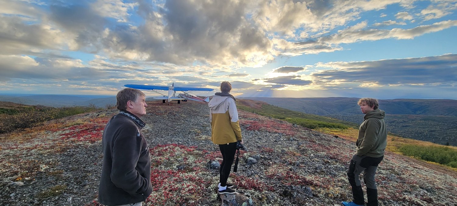 Family on Alaska’s open tundra in evening light